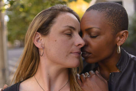 Romantic and fun portrait of a young lgbt couple on an urban background