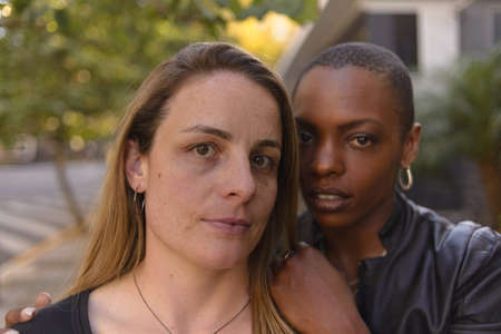 Romantic and fun portrait of a young lgbt couple on an urban backgroundの写真素材
