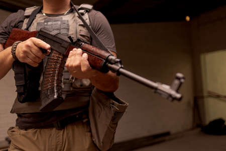 Soldier with rifle indoors
