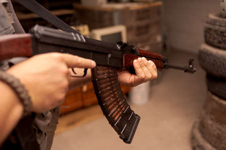 Soldier with rifle indoorsの写真素材