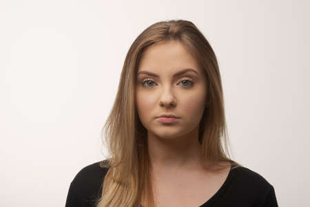 Portrait of white caucasian woman angry disappointed furious in white background studioの写真素材