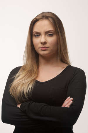 Portrait of white caucasian woman angry disappointed furious in white background studioの写真素材