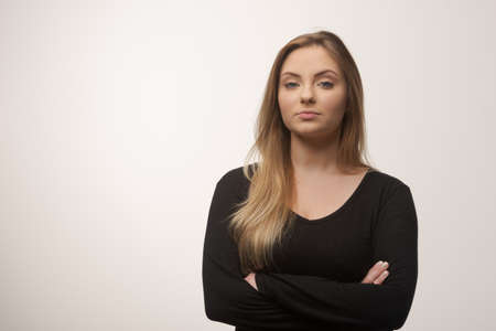 Portrait of white caucasian woman angry disappointed furious in white background studioの写真素材
