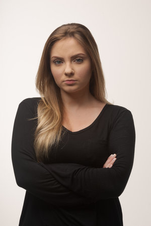 Portrait of white caucasian woman angry disappointed furious in white background studioの写真素材
