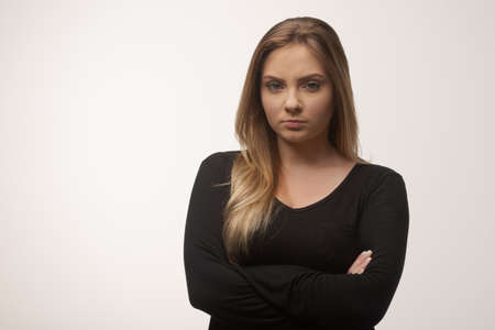 Portrait of white caucasian woman angry disappointed furious in white background studioの写真素材