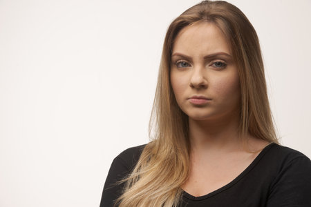 Portrait of white caucasian woman angry disappointed furious in white background studioの写真素材