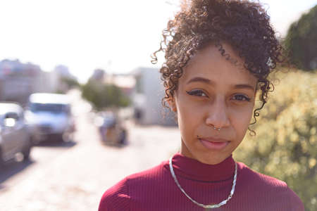 Black young woman portrait outdoors in urban landscapeの写真素材
