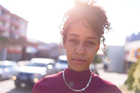 Black young woman portrait outdoors in urban landscapeの写真素材