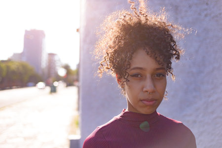 Black young woman portrait outdoors in urban landscapeの写真素材