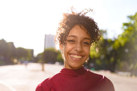 African American young woman portrait outdoors in urban landscapeの写真素材