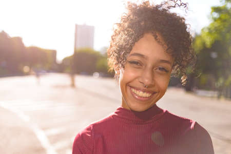 African American young woman portrait outdoors in urban landscapeの写真素材