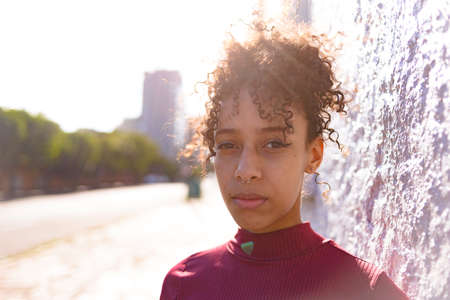African American young woman portrait outdoors in urban landscapeの写真素材