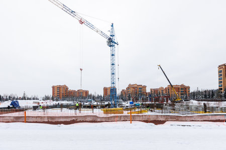 the construction site of an apartment building in the winter from a heightの写真素材