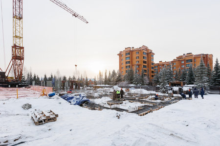 the construction site of an apartment building in the winter from a heightの写真素材