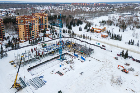 the construction site of an apartment building in the winter from a heightの写真素材