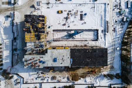 the construction site of an apartment building in the winter from a height