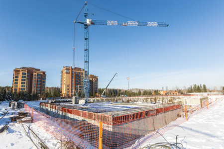 the construction site of an apartment building in the winter from a heightの写真素材