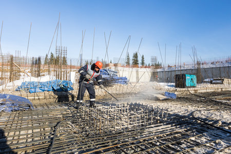 the construction site of an apartment building in the winter from a height