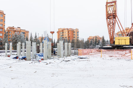 the construction site of an apartment building in the winter from a heightの写真素材