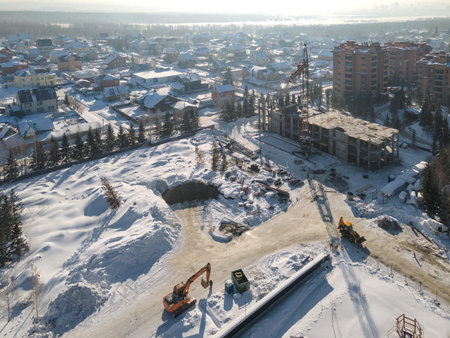 the construction site of an apartment building in the winter from a heightの写真素材
