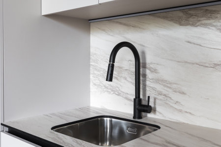 kitchen faucet on a stylish metal sinkの写真素材