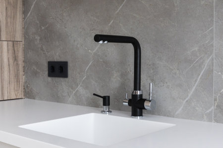 kitchen faucet on a stylish metal sinkの写真素材