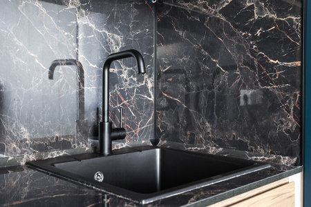 kitchen faucet on a stylish metal sinkの写真素材