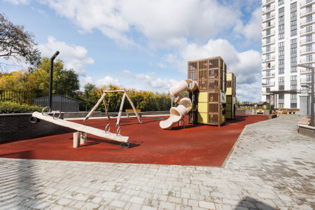 Children's playground in the courtyard of a multi-storey buildingの写真素材