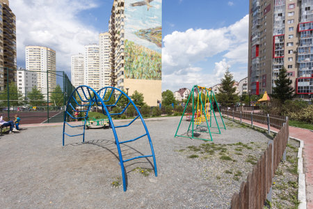 Children's playground in the yard of a multi-storey building