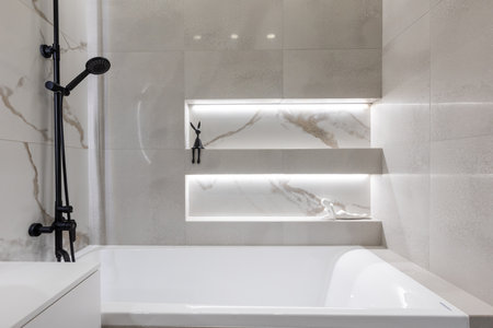 modern bathroom with bathtub and illuminated wall niches