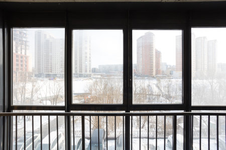 the balcony of an apartment on the upper floors of an apartment buildingの写真素材
