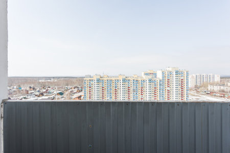 the balcony of an apartment on the upper floors of an apartment buildingの写真素材