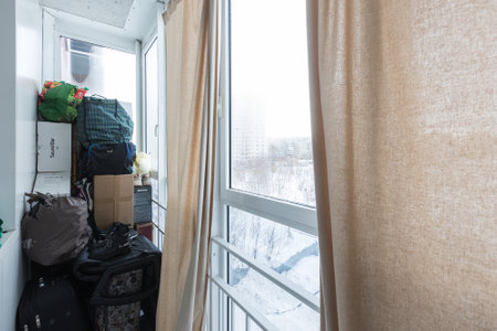 the balcony of an apartment on the upper floors of an apartment buildingの写真素材