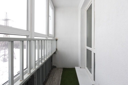 the balcony of an apartment on the upper floors of an apartment buildingの写真素材