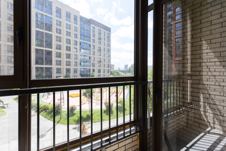 the balcony of an apartment on the upper floors of an apartment buildingの写真素材
