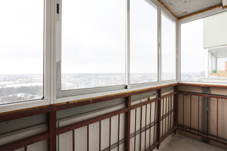 the balcony of an apartment on the upper floors of an apartment building