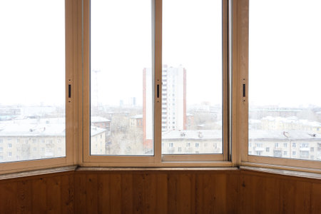 the balcony of an apartment on the upper floors of an apartment buildingの写真素材