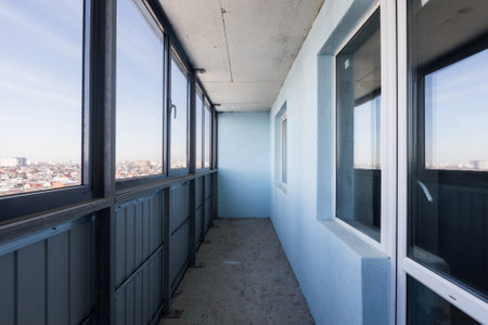 the balcony of an apartment on the upper floors of an apartment buildingの写真素材