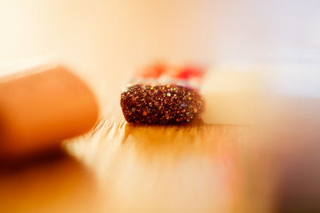 Red and white pills on wooden table. Focus on foreground, shallow DOF.の写真素材
