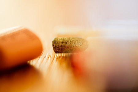 Close up of pills on wooden table. Focus on foreground, shallow DOF.の写真素材