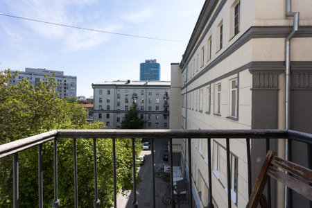 the balcony of an apartment on the upper floors of an apartment buildingの写真素材