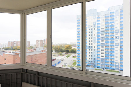 the balcony of an apartment on the upper floors of an apartment buildingの写真素材