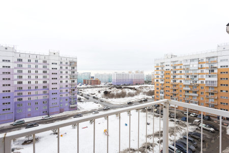 the balcony of an apartment on the upper floors of an apartment buildingの写真素材