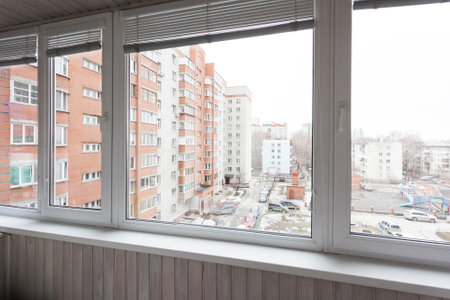 the balcony of an apartment on the upper floors of an apartment buildingの写真素材