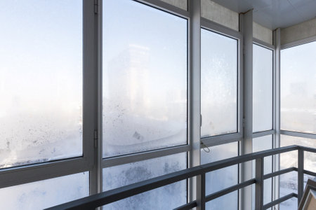 the balcony of an apartment on the upper floors of an apartment buildingの写真素材