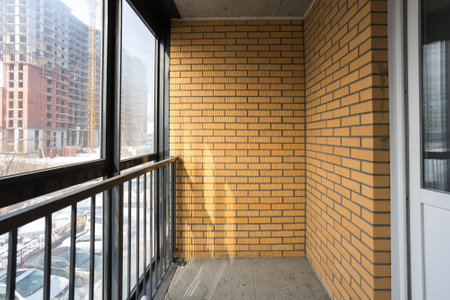 the balcony of an apartment on the upper floors of an apartment buildingの写真素材