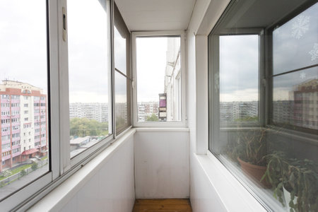 the balcony of an apartment on the upper floors of an apartment buildingの写真素材