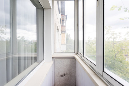 the balcony of an apartment on the upper floors of an apartment building