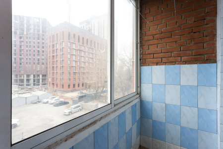 the balcony of an apartment on the upper floors of an apartment buildingの写真素材