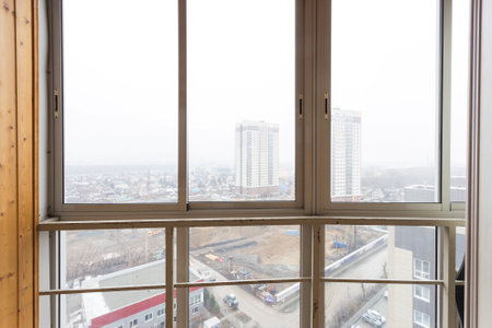 the balcony of an apartment on the upper floors of an apartment buildingの写真素材